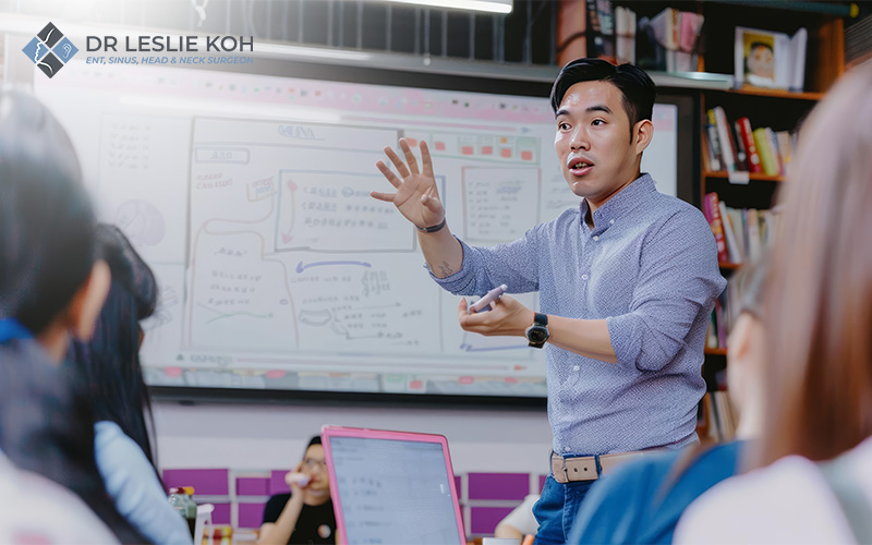 Male instructor explaining a topic on a digital whiteboard.