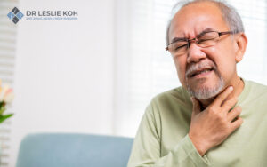 old man in pain holding his neck