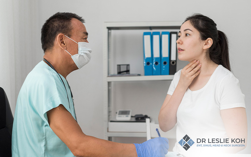 woman consulting her throat condition to a doctor