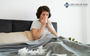 woman suffering from sneezing fits due to morning sinus