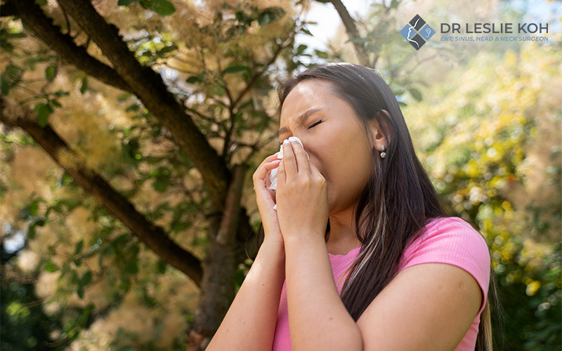 woman sneezing on a tissue