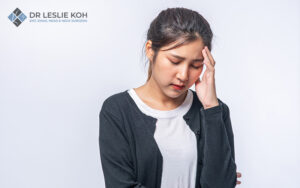 Woman suffering a bout of dizziness after standing up.