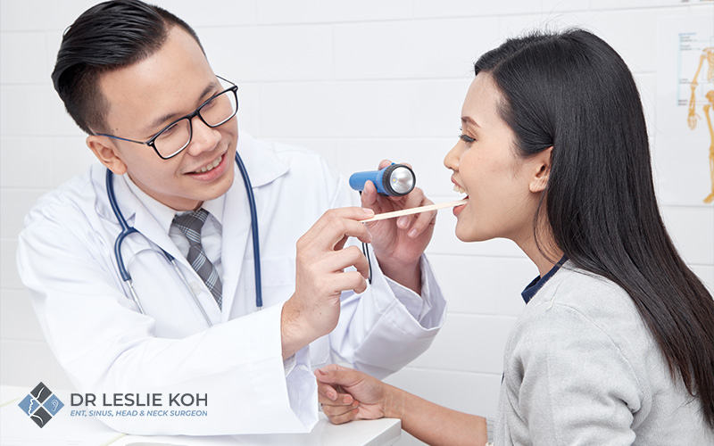 doctor checking patients throat