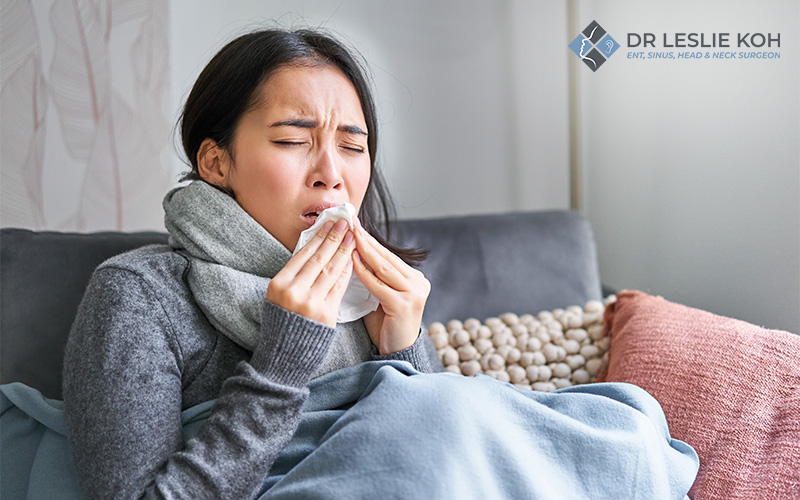 Woman sneezing from allergic rhinitis or sinusitis.