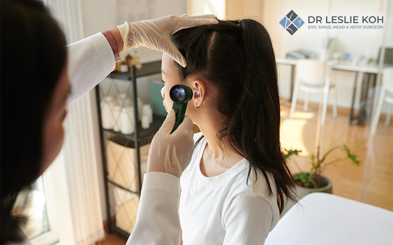 girl having his ear checked by an ENT doctor
