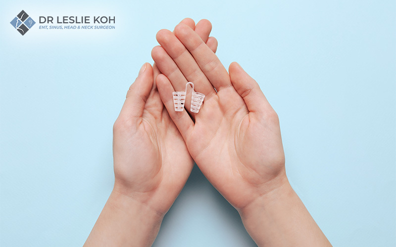 hands carrying an anti snoring device