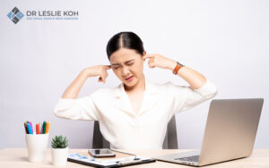 woman covering her ears seemingly annoyed